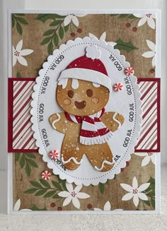 a christmas card with a ginger bear wearing a santa hat and holding a candy cane