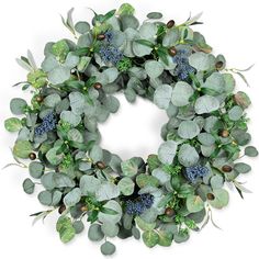 a wreath with green leaves and blue berries