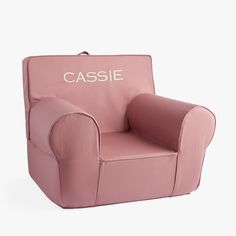 a pink children's chair with the word cassie written on it in white lettering