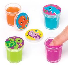 a finger touching some plastic cups with different designs on them and one has its thumb in the cup