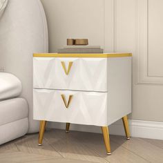 a white and gold nightstand with two drawers on it in the corner of a room