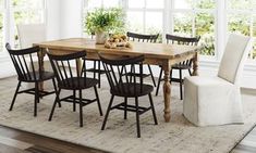 a dining room table with chairs and a potted plant on top of the table