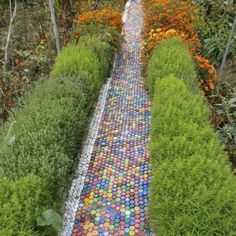 a walkway made out of plastic balls in a garden