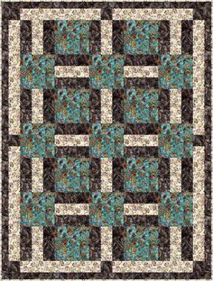 a blue and brown quilt with squares on it's sides, in the center