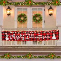 a merry christmas banner hanging from the side of a building