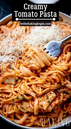 creamy tomato pasta with chicken and parmesan cheese in a skillet, ready to be eaten