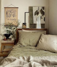 a bed sitting in a bedroom next to a window with lots of pillows on top of it