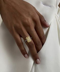 a close up of a person's hand wearing a ring