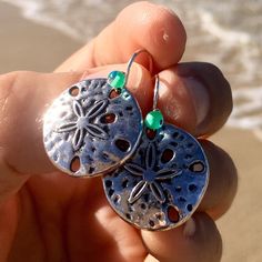 gorgeous and elegant silver sand dollar earrings perfect gift for beach lovers! * silver sand dollar * hypoallergenic stainless steel silver french hook ear wires  * transparent teal glass accent beads * add a matching bracelet! Handmade by me with Aloha in Hawaii they arrive ready for gifting with my LIVE ALOHA card, inside a delicate deep ocean blue organza bag. *to ensure safety in transit, earrings are now shipped inside a cute, reusable acrylic jar along with my Live Aloha card and organza bag* SEE ALL MY EARRINGS HERE: https://www.etsy.com/shop/LOphoto808?ref=br_feed_17&br_feed_tlp=art§ion_id=17783609 shipping additional items is FREE!! please contact me here: https://www.etsy.com/conversations/new?with_id=30970463 if you need assistance with ordering or have any questions. PLEASE VI Nickel Free Sterling Silver Jewelry For Beach, Nickel-free Sterling Silver Jewelry For The Beach, Ocean-inspired Silver Jewelry For The Beach, Silver Beachy Jewelry For Beach Occasions, Silver Ocean-inspired Jewelry For The Beach, Silver Ocean-inspired Jewelry For Beach, Beachy Silver Beach Jewelry, Ocean-inspired Silver Beach Jewelry, Silver Jewelry For Beach Season Vacation