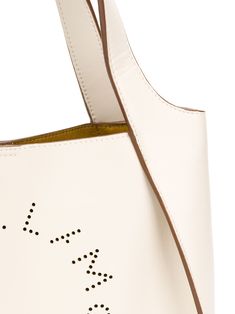 Best friends come in all shapes and sizes - it just so happens that this one comes in the form of a Stella McCartney small logo tote. Crafted from white faux leather, this hero piece keeps it nice and simple, with a minimal design decorated only by the perforated logo to the front. A friend for life. Featuring top handles, a detachable shoulder strap, a magnetic fastening, a removable pouch and a perforated logo design to the front. POSITIVELY CONSCIOUS: We’ve joined forces with ethical agency G Beige Leather Shoulder Bag With Logo, Tan Leather Bag With Logo, Everyday Bucket Bag With Logo, Everyday Bucket Bags With Logo, Beige Logo Shoulder Bag For Errands, Modern Medium Shoulder Bag For Errands, Everyday Use Bucket Bags With Logo, White Shoulder Bag With Logo And Double Handle, Beige Logo Tote Shoulder Bag