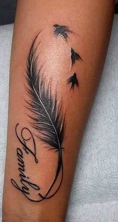 a black and white photo of a feather tattoo