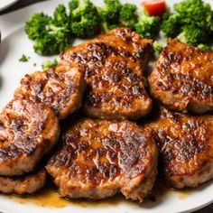 some meat and broccoli on a white plate