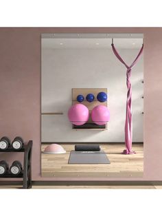 there is a yoga mat and pink balls on the wall in this room with other items