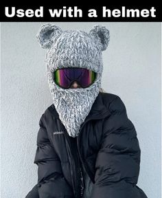 a person wearing a knitted bear hat and sunglasses with the caption used with a helmet