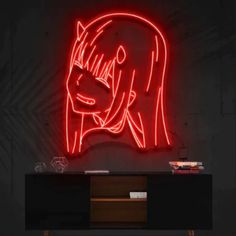 a red neon sign that is on the side of a wall next to a black cabinet