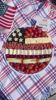 an american flag platter on a picnic table with grapes, cheese and crackers