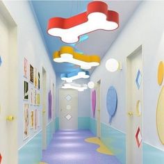 the hallway is painted in bright colors and has an unusual ceiling light that hangs from the ceiling