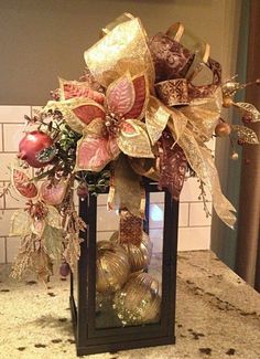 a lantern filled with ornaments on top of a counter