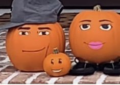 three pumpkins with faces painted on them sitting next to each other, one wearing a hat