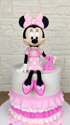 a minnie mouse cake with pink and white ruffles