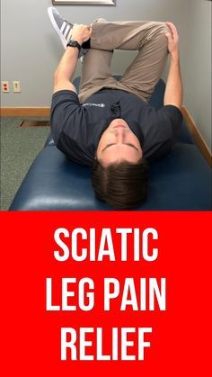 a man laying on top of a blue couch in front of a red sign that says sciatic leg pain relief