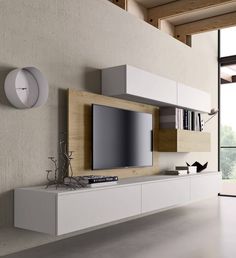 a white entertainment center with a flat screen tv mounted on it's side wall