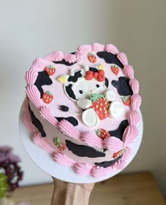 a hello kitty cake on a wooden table