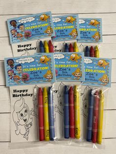 four happy birthday crayons in plastic bags with stickers on the front and back