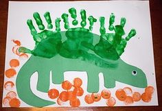 this is an image of handprints made to look like a dinosaur with green hands