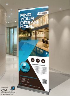 a roll up banner is displayed on the floor in front of a building with an indoor swimming pool