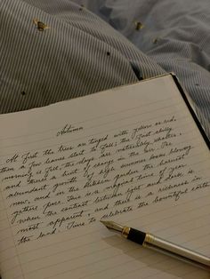 an open notebook with writing on it next to a pen