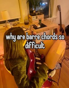 a girl with long hair holding a guitar in her lap and texting, why are bare chords so difficult?