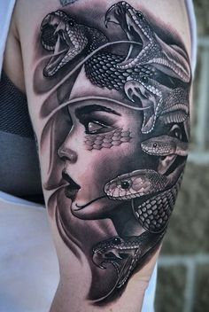 a woman's arm with tattoos on it and snakes around her head in black and white