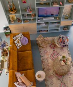 an overhead view of a living room with couches, coffee table and television set