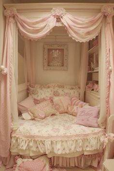 a canopy bed with pink and white decor in a girls's room or bedroom