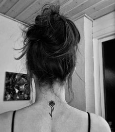 a woman with a flower tattoo on her back