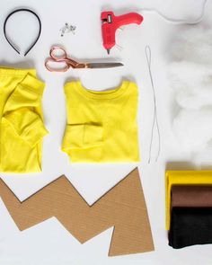 sewing supplies laid out on a table with scissors and paper cutouts to make t - shirts