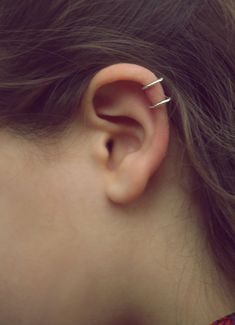 a close up of a person with an ear piercing