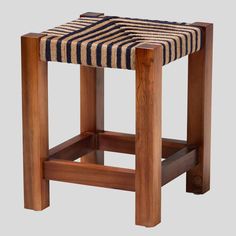 a wooden stool with a striped seat cushion