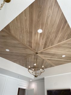 a ceiling with wooden planks and lights