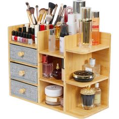 a wooden shelf filled with lots of cosmetics and makeup products on top of each other