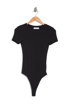 a black bodysuit hanging on a hanger with the tag attached to it's chest