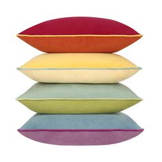 four pillows stacked on top of each other with different colors and sizes in the middle