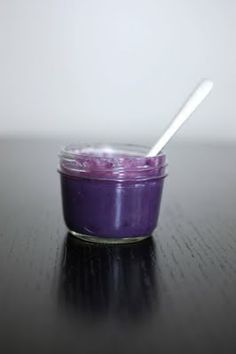 a small glass jar filled with purple liquid