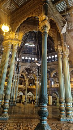 the inside of a building with columns and lights