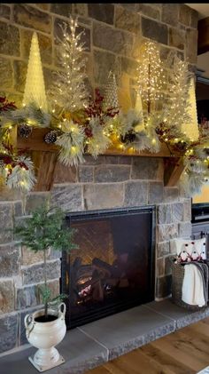 a fireplace decorated with christmas trees and lights