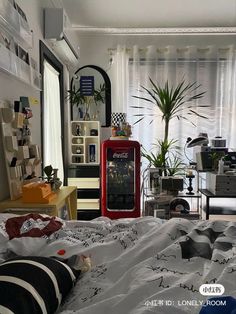 a bed room with a neatly made bed and lots of plants on the windowsill