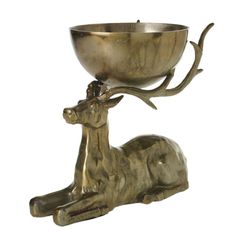 a metal bowl that is sitting on top of a deer's head and legs