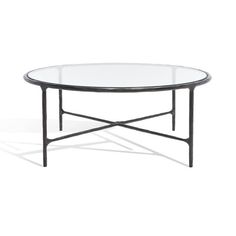 an oval glass table with black metal legs and a circular glass top, against a white background