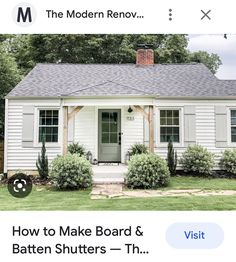 a small white house sitting on top of a lush green field